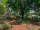 Lush backyard featuring mature trees, landscaping, and serene retreat at 11530 Arlhuna Way, Dade City, FL 33525