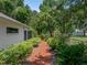 Lush backyard featuring mature landscaping and private retreat at 11530 Arlhuna Way, Dade City, FL 33525