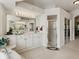 Bright bathroom featuring white cabinetry, a walk-in shower, and a large mirror with ample lighting at 11530 Arlhuna Way, Dade City, FL 33525