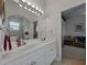 Bright bathroom features dual sinks, white cabinets, and a large mirror with vanity lighting at 11530 Arlhuna Way, Dade City, FL 33525