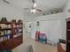 Bedroom with built-in bookshelves, a closet, and neutral carpeting at 11530 Arlhuna Way, Dade City, FL 33525