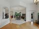 View of the dining room featuring a dark table with a chandelier, and connecting hallway spaces at 11530 Arlhuna Way, Dade City, FL 33525