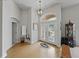 Bright foyer featuring high ceilings, double front doors, decorative chandelier, and a mirror at 11530 Arlhuna Way, Dade City, FL 33525