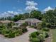 Landscaped front yard and curved driveway leading to a well-maintained home with an attached two-car garage at 11530 Arlhuna Way, Dade City, FL 33525