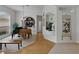 View of a hallway with hardwood floors and art pieces, which connects the rooms within the house at 11530 Arlhuna Way, Dade City, FL 33525