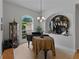 The living room has a grand piano, curio cabinet, and large black asian decorative piece above a sideboard at 11530 Arlhuna Way, Dade City, FL 33525