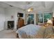 Spacious main bedroom offering neutral decor, fan, tray ceiling, and a sunroom view at 11530 Arlhuna Way, Dade City, FL 33525