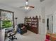 Home office featuring built-in bookshelves, two chairs, and a large window at 11530 Arlhuna Way, Dade City, FL 33525