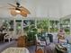 Enclosed sunroom with beautiful views of the outdoors with cozy seating arrangements at 11530 Arlhuna Way, Dade City, FL 33525