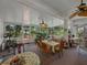 Enclosed sunroom provides natural light and air with ceiling fans and beautiful views of the outdoors at 11530 Arlhuna Way, Dade City, FL 33525