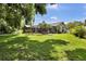 Expansive backyard with a screened-in patio, mature trees, and plenty of green space at 12219 Steppingstone Blvd, Tampa, FL 33635