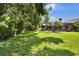 Expansive backyard showing mature trees and screened lanai at 12219 Steppingstone Blvd, Tampa, FL 33635