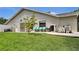 Backyard featuring well maintained yard and patio seating at 12219 Steppingstone Blvd, Tampa, FL 33635
