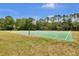 Outdoor basketball court featuring multiple hoops, a green surface, and surrounding trees at 12219 Steppingstone Blvd, Tampa, FL 33635