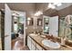 Well-lit bathroom featuring double sinks and a view of the adjacent bedroom at 12219 Steppingstone Blvd, Tampa, FL 33635