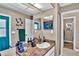 Bathroom features a granite countertop sink, artistic decor, and an adjacent doorway at 12219 Steppingstone Blvd, Tampa, FL 33635