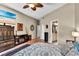 A well-lit bedroom with hardwood floors, modern decor, and a television at 12219 Steppingstone Blvd, Tampa, FL 33635