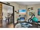 Inviting bedroom featuring exercise equipment, an electric fireplace, and an open floor plan at 12219 Steppingstone Blvd, Tampa, FL 33635