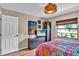 Cozy bedroom with a colorful quilt, wooden floors, and plenty of natural light at 12219 Steppingstone Blvd, Tampa, FL 33635
