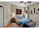 A naturally lit bedroom featuring African-themed decor and hardwood floors at 12219 Steppingstone Blvd, Tampa, FL 33635