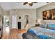 A well-lit bedroom with hardwood floors, modern decor, and an ensuite bathroom at 12219 Steppingstone Blvd, Tampa, FL 33635