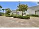 Well-maintained building exterior with manicured landscaping and beautiful mature trees at 12219 Steppingstone Blvd, Tampa, FL 33635