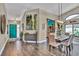 View of foyer and dining area with wood flooring and teal front door at 12219 Steppingstone Blvd, Tampa, FL 33635