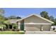 Charming single Gathering home showcasing a teal front door and well-manicured lawn at 12219 Steppingstone Blvd, Tampa, FL 33635