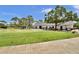 Scenic golf course view featuring a lush green lawn, golf carts, and a charming clubhouse at 12219 Steppingstone Blvd, Tampa, FL 33635