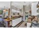 Open-concept kitchen with stainless steel appliances, pantry shelving and breakfast bar at 12219 Steppingstone Blvd, Tampa, FL 33635