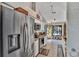 Bright kitchen with stainless steel appliances and access to the outdoor pool area at 12219 Steppingstone Blvd, Tampa, FL 33635