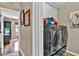 Bright laundry room with modern washer and dryer units and white built-in cabinets at 12219 Steppingstone Blvd, Tampa, FL 33635