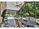 Relaxing screened patio boasts brick floors, tv, grill and views of the pool at 12219 Steppingstone Blvd, Tampa, FL 33635