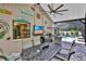 Relaxing screened patio boasts brick floors, tv, grill and views of the pool at 12219 Steppingstone Blvd, Tampa, FL 33635
