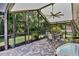 Relaxing screened patio boasts brick floors, grill and views of the back yard at 12219 Steppingstone Blvd, Tampa, FL 33635