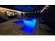 Backyard pool with blue custom lighting, surrounded by a brick patio, and lounge seating at 12219 Steppingstone Blvd, Tampa, FL 33635