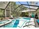 Inviting backyard pool and spa with a screened enclosure and ample seating areas at 12219 Steppingstone Blvd, Tampa, FL 33635