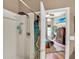 Bright shower with a rainfall showerhead and decorative shower curtain, connecting to a bedroom at 12219 Steppingstone Blvd, Tampa, FL 33635