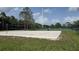 Picturesque sand volleyball court with a clear net, set against a backdrop of lush greenery at 12219 Steppingstone Blvd, Tampa, FL 33635