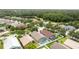 Aerial view of a serene community with lush trees, a pond, and well-maintained properties at 12229 Coldstream Ln, Tampa, FL 33626