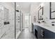 This bathroom has a walk in shower and double vanity with black hardware and white quartz countertop at 12229 Coldstream Ln, Tampa, FL 33626