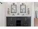 This bathroom has a double vanity with black hardware, white quartz countertops, and plank accent wall at 12229 Coldstream Ln, Tampa, FL 33626