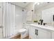 Well-lit bathroom featuring a shower-tub combo with white tiling, modern sink and vanity, and neutral wall color at 12229 Coldstream Ln, Tampa, FL 33626