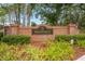 Elegant brick community entrance sign for Sheffield, adorned with lush greenery and landscaping at 12229 Coldstream Ln, Tampa, FL 33626