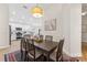 Dining area with a wooden table, seating for six, an eye-catching light fixture, and wood-look tile flooring at 12229 Coldstream Ln, Tampa, FL 33626