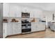 Stylish kitchen with stainless steel oven, microwave, white cabinets, and white tile backsplash at 12229 Coldstream Ln, Tampa, FL 33626