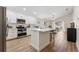 Modern kitchen featuring stainless steel appliances, white cabinets and island with breakfast bar at 12229 Coldstream Ln, Tampa, FL 33626