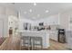 Bright kitchen features white cabinets, stainless appliances, a breakfast bar, and wood-look tile flooring at 12229 Coldstream Ln, Tampa, FL 33626