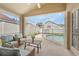 Covered lanai offers comfortable seating, a ceiling fan, and a view of the screened pool area at 12229 Coldstream Ln, Tampa, FL 33626