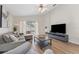 Inviting living room with access to the lanai, wood-look floors, and neutral decor at 12229 Coldstream Ln, Tampa, FL 33626